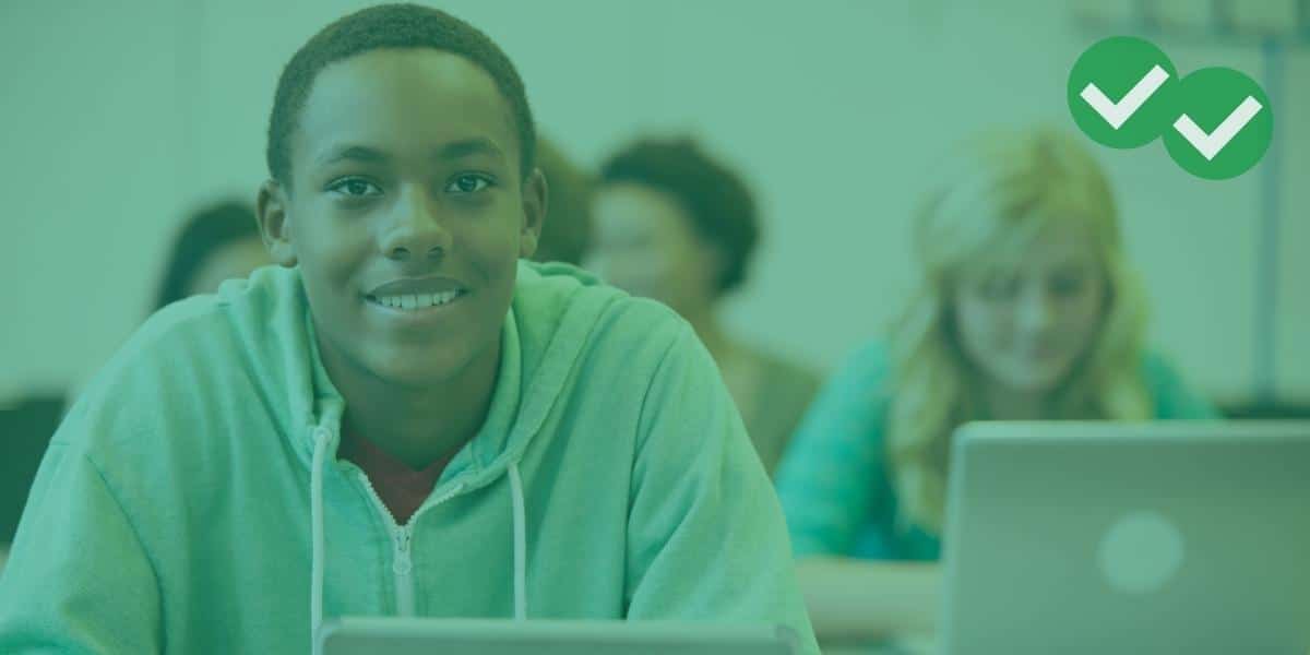 A smiling high school student with more students in the background