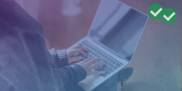 A woman typing on a laptop keyboard