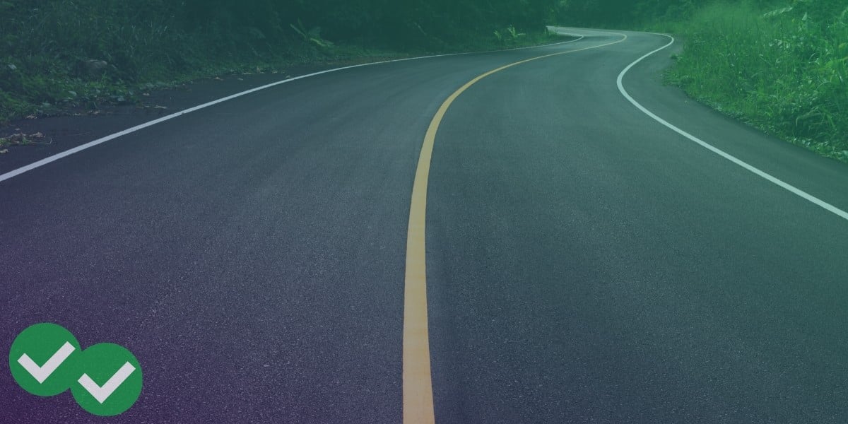 Windy paved road with yellow solid stripe down the middle, representing the student's journey preparing for the ACT - image by Magoosh