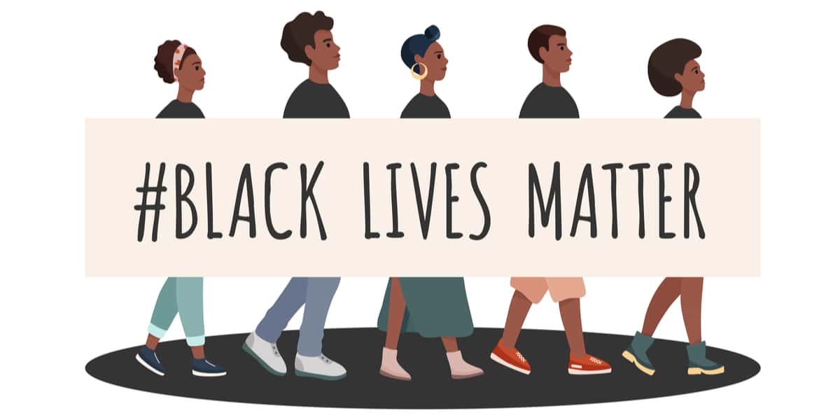 Black men and women walking together with banner saying black lives matter