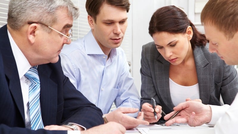 Group of people business suits representing how to describe yourself in an interview as a team player