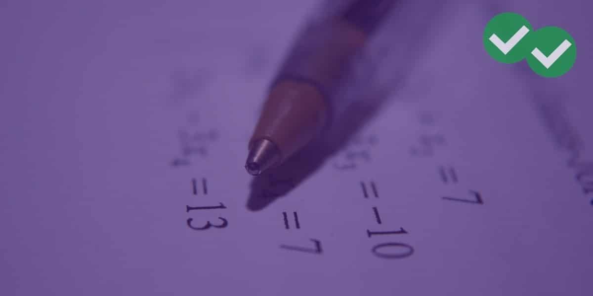 Pen over a page of math formulas representing GRE Math Formulas Cheat Sheet - magoosh