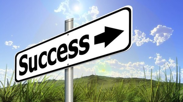 Sign pointing toward success