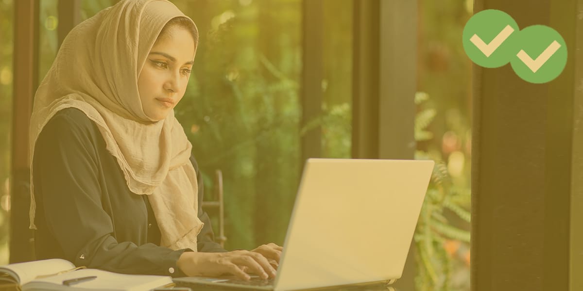 a woman in hijab viewing her computer