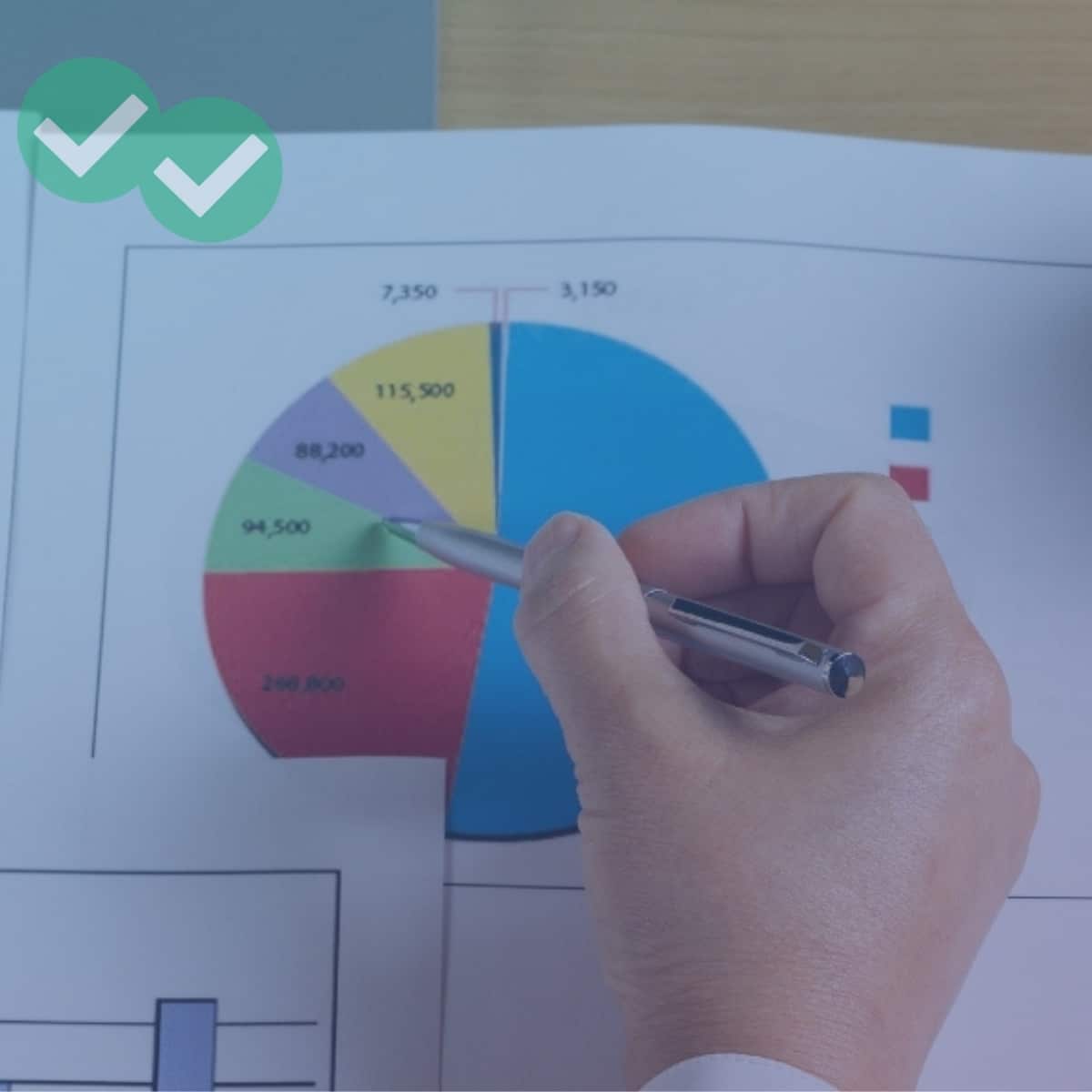 Hand holding pen pointing at IELTS Writing Task 1 pie chart
