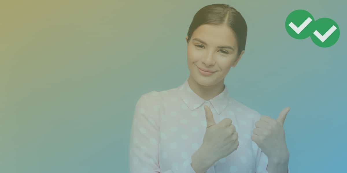 Person holding 2 thumbs up to represent IELTS agree disagree essay