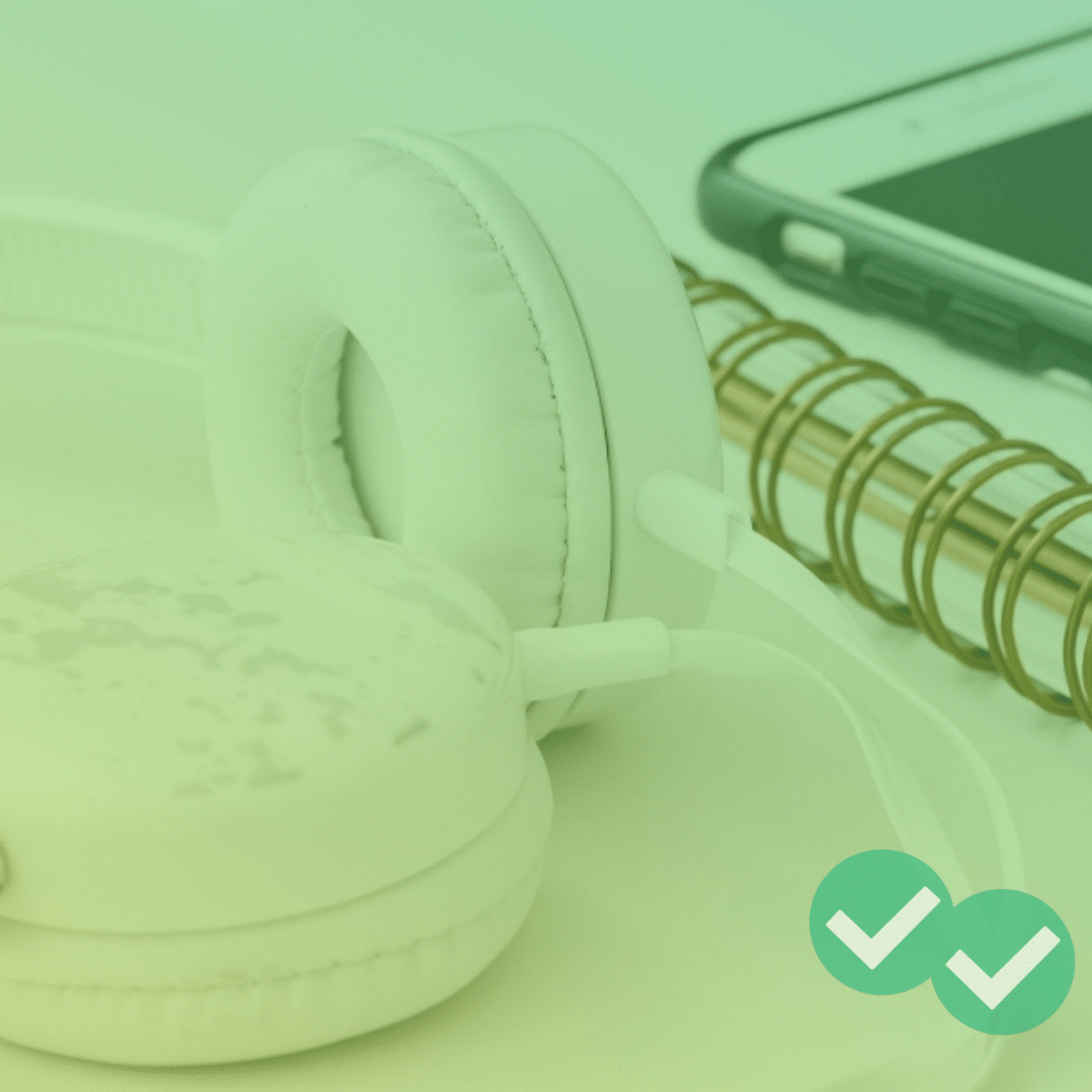 Headphones next to notebook and phone
