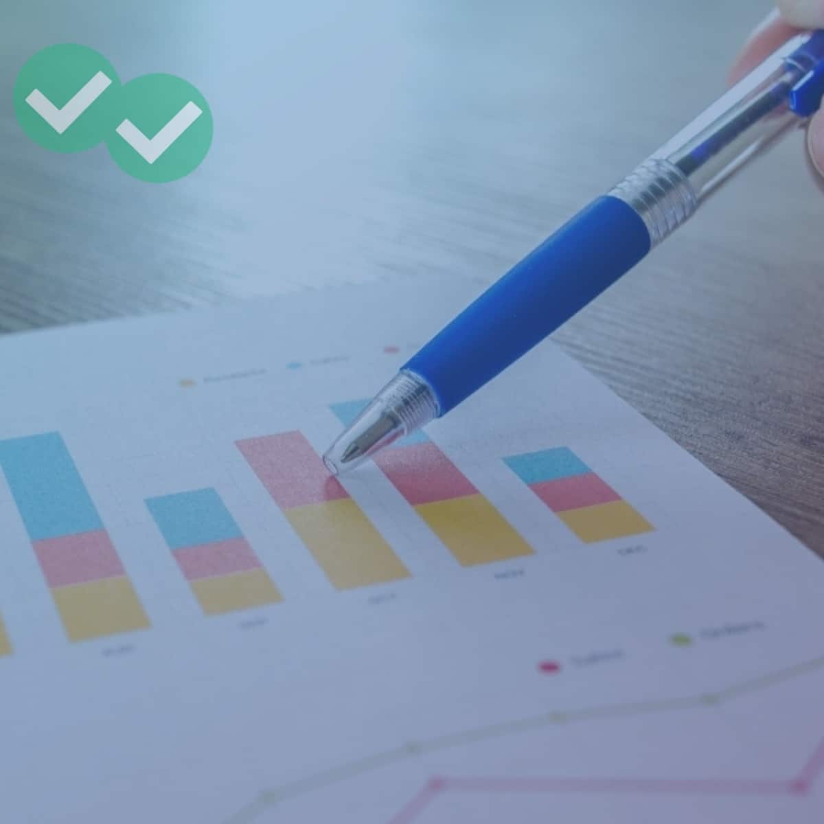 Pen pointing at multicolored IELTS writing bar charts - image by Magoosh