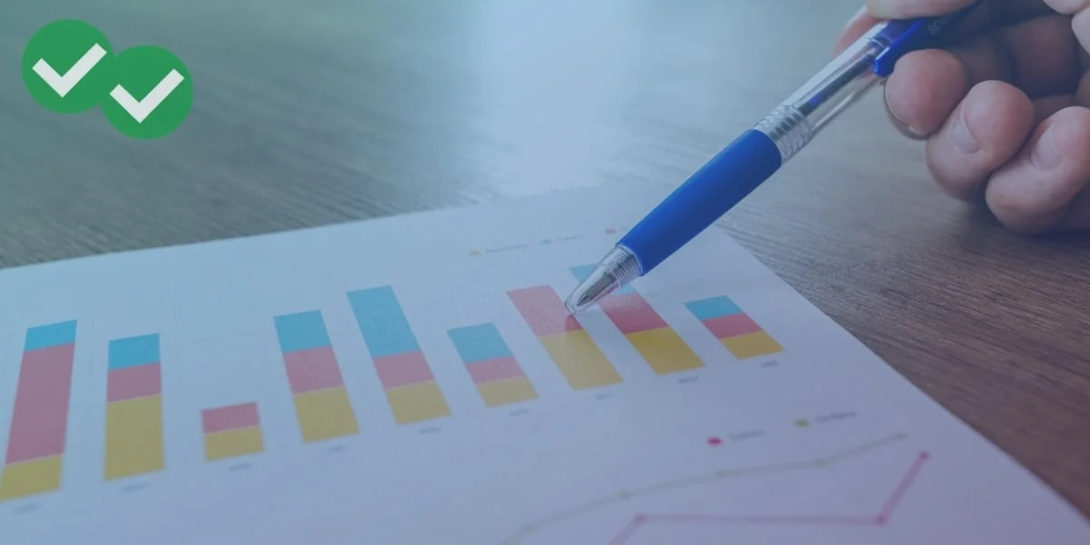 Pen pointing at multicolored IELTS writing bar charts - image by Magoosh