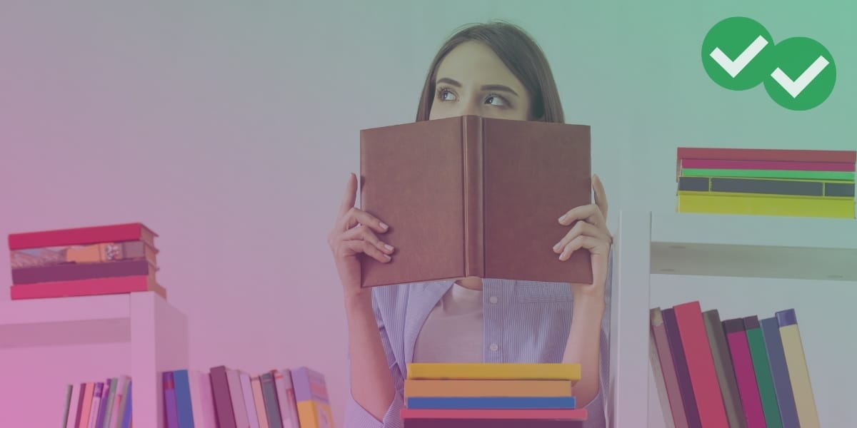 Student looking up from pile of reading practice books