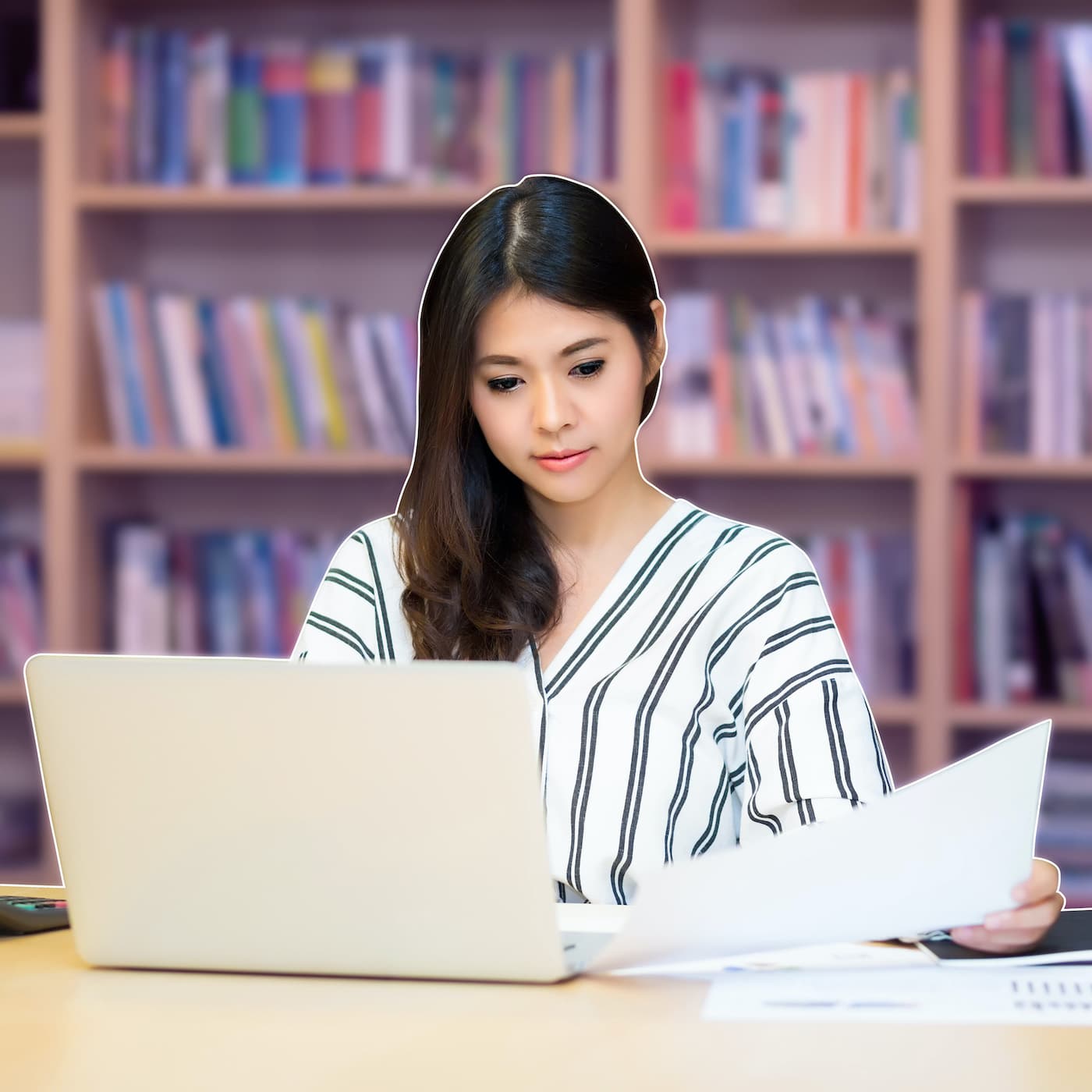 woman studying with laptop in library