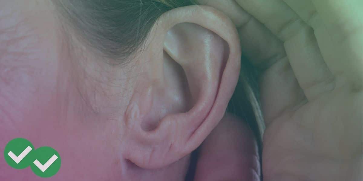a woman cups her ear (companion image for our post that offers a toefl listening practice test with answers pdf)