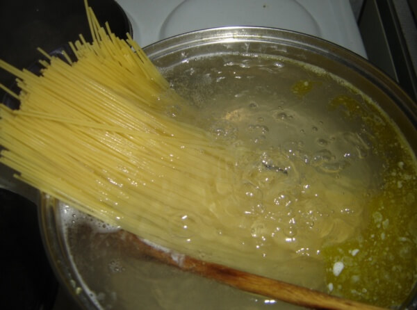 Spaghetti noodles starting to boil